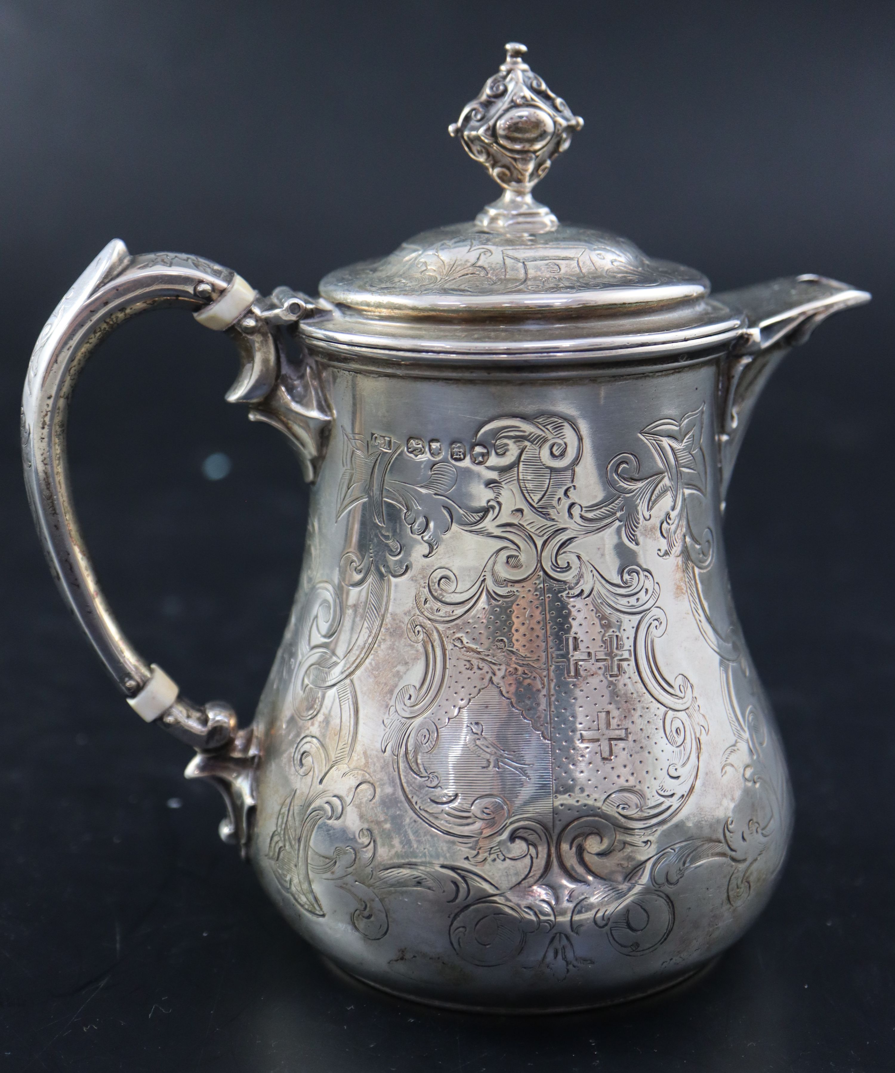 A Victorian small engraved silver hot water pot, 5.7cm, gross 10.5oz.